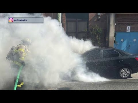 NJ Garfield Police Extinguish A Car Fire Outside Of A School