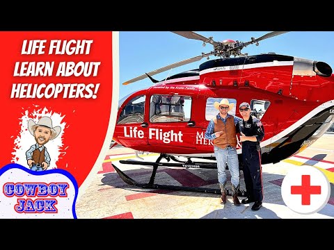 Two men in cowboy outfits pose beside a bright red Life Flight helicopter on a sunny tarmac behind the scene banner. The left shows a bold 'Life Flight Learn About Helicopters!' graphic.