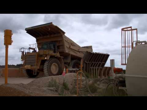 haul truck dumping into crusher