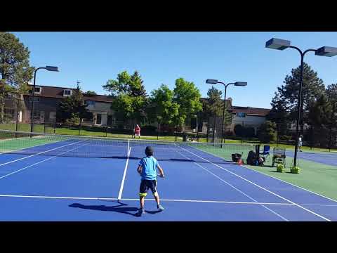 8 years old Teo playing ambidextrous tennis at the net