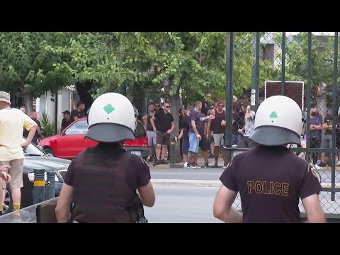 AEK fans protest outside a court in Athens where men accused for deadly violence were taken