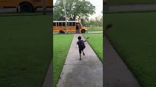 Little Boy Falls Onto Grass While Running to Catch School Bus - 1361653
