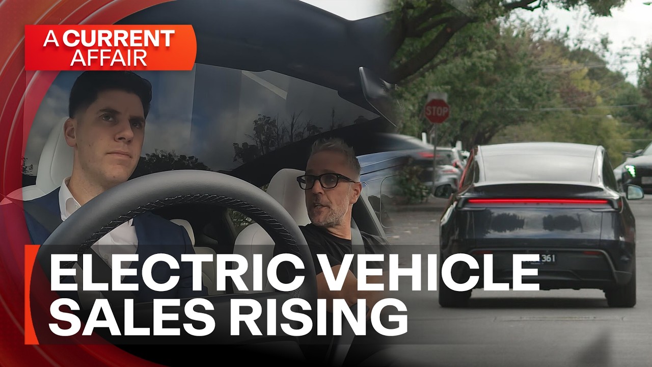 A Current Affair reporter beside a Tesla Model Y in Melbourne during coverage of Australia's record EV sales in March 2026