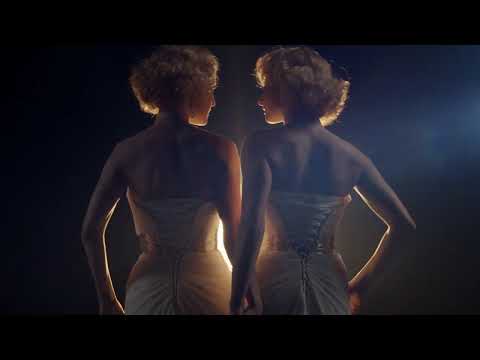 Side Show TV commercial frame showing Daisy and Violet in vaudeville glamour