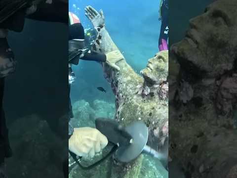 Divers clean famous underwater statue off Italian coast