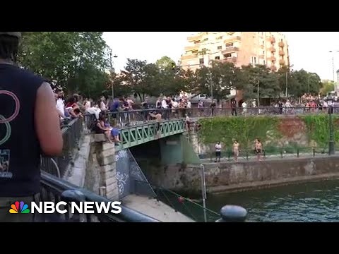 Europe heatwave: Watch Parisians jump into canal during NBC reporter's live shot