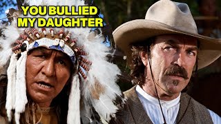 The cowboy protects the Native girl from the white men