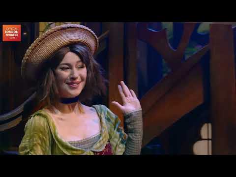 Trailer frame of Belle reading as enchanted objects whirl around her