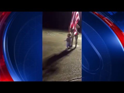 Little boy shakes hands of those who serve, showing respect and honor