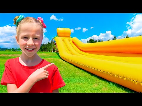 Nastya and Evelyn play outside with a huge trampoline