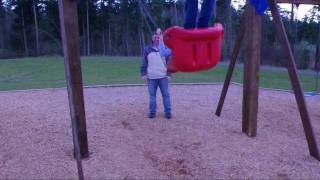Father pushing daughter on swing - K7