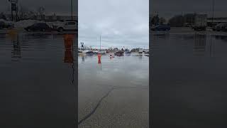 Kayaker traverses flooded Escanaba parking lot