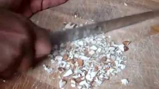 Chopping Amond nuts by hand using a  knife