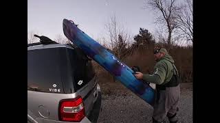 Car topping a sit on top kayak on a large SUV