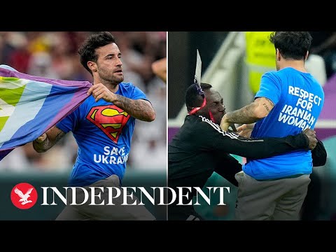 Pitch invader waving pride flag tackled after storming World Cup match