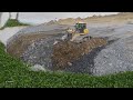Great Skilled Driver Of Bulldozer Operator Spreading Dirt Rock With Dump Truck On Road Construction