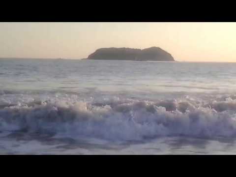 Playa Espadilla, Costa Rica, standing in the surf at sunset