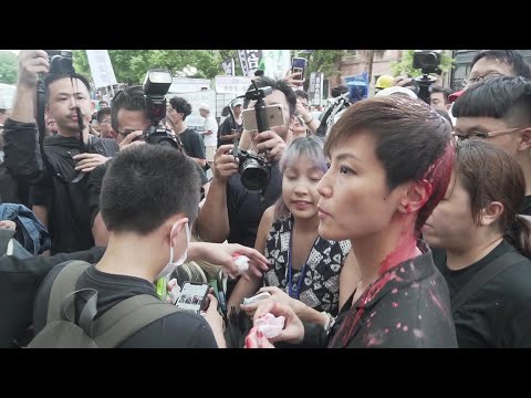 Hong Kong popstar Denise Ho doused with red paint by masked man at Taiwan rally | AFP