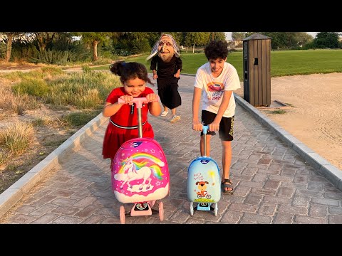 Children play on scooters in the park