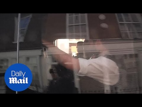 Police vehicle believed to be carrying Julian Assange leaves court