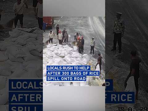 Locals rush to help after 300 bags of rice spill onto road
