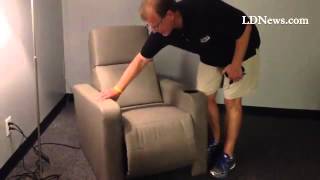 Paul Wenger, VP of Flagship Cinemas, demonstrates the chairs that will be installed in their Palmyra