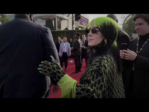 Trailer shot of crowd hands up during Billie Eilish concert sequence