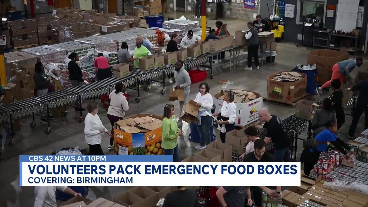 Volunteers pack emergency food boxes for families