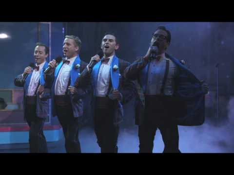 Forever Plaid trailer frame highlighting quartet harmonizing on stage lights