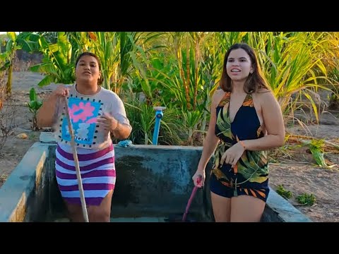 Sophia and her friends washing the tub at the farm before taking a bath.