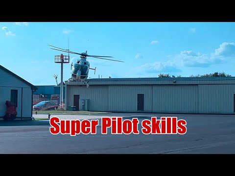 Unreal Precision: Helicopter Lands Between Two Hangars