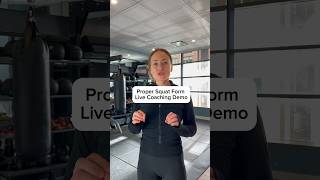 Coaching my client through proper squat form in my
