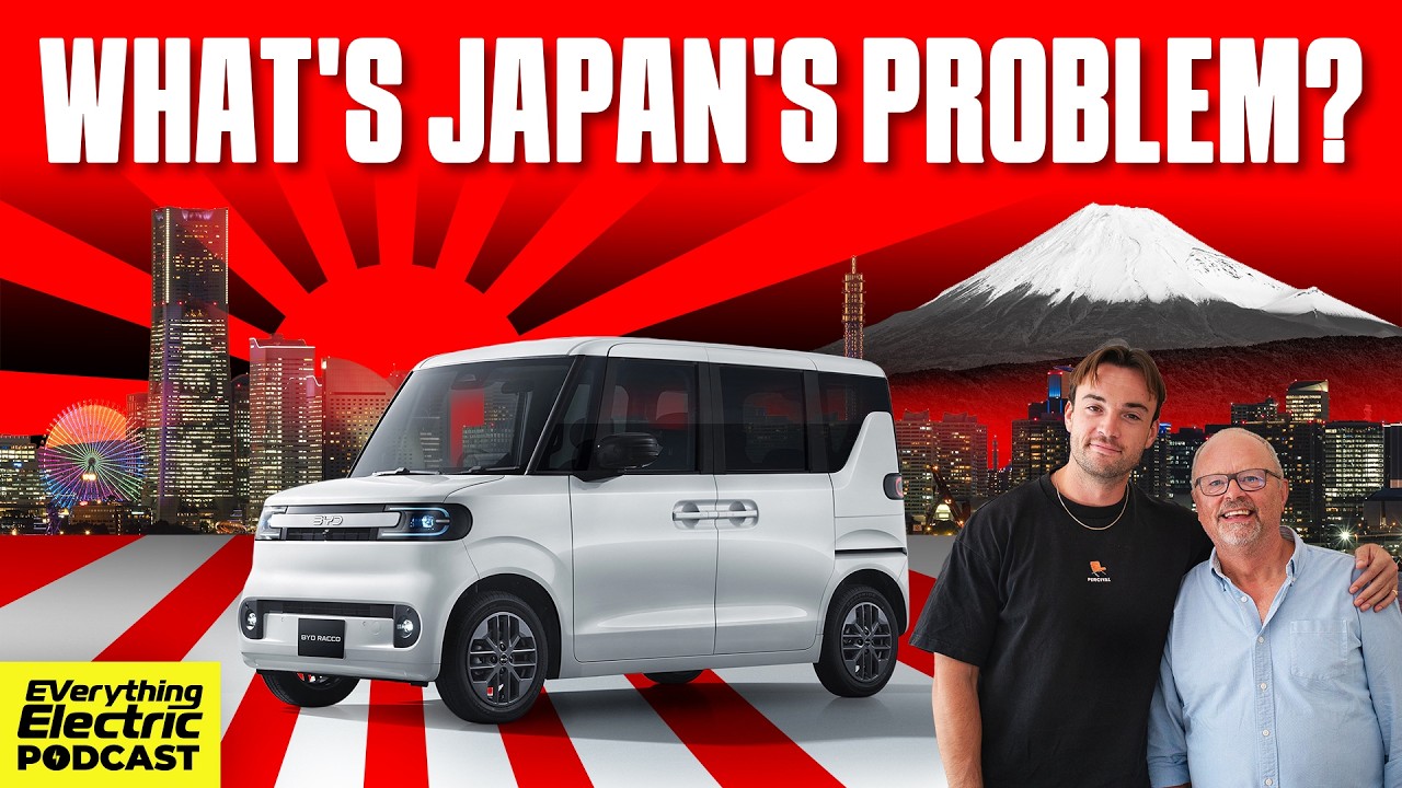 Traffic on a Tokyo street with kei cars and minivans