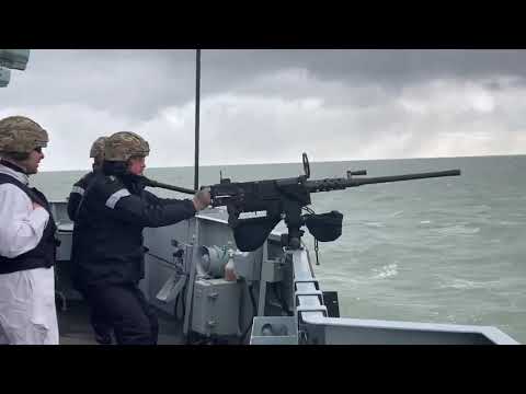 HMS Lancaster fires.50 (12.7mm) calibre heavy machine gun
