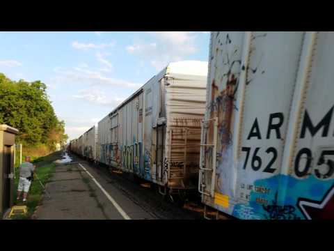 CSX #5102 Box Car and Hopper Train Speeds Through the Amsterdam Amtrak Station in Amsterdam, NY