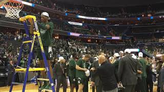 Michigan State players celebrate and cut down the nets