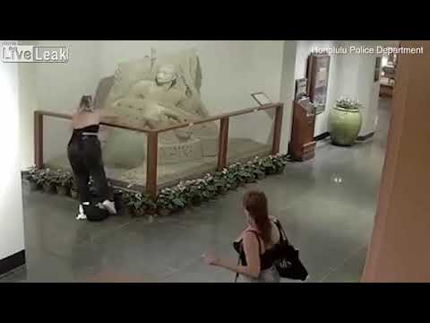 Women destroy a hotels sand castle display