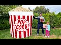 A Giant Bucket Of Popcorn With Crispy Chicken Strips And Potato Fries
