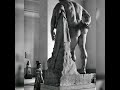 a woman looking up at the Farnese Hercules, a Roman sculpture from the early third century A.D. ...