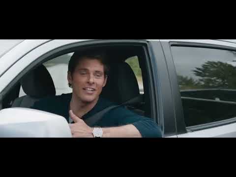 Trailer still: Sonic and Tom in a pickup at night, road-trip buddy energy under a pulsing cue