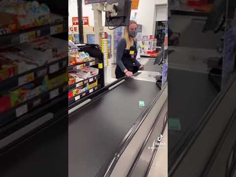 Cashier is waiting on tictacs to go all the way down the conveyor belt.