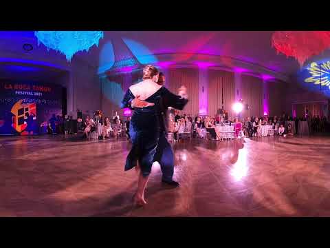  Liza Rosales  and  Juan Manuel Rosales  are  dancing  to  the  vals  "  Dichas Que Vivi  "  by  Rodolfo Biagi  at  La Boca Tango Festival  in  2021