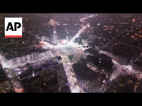 Phones glow in night at silent anti-government protest in Serbia