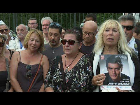 Mourning fans sing 'Paroles, paroles' outside French actor Alain Delon's estate | AFP