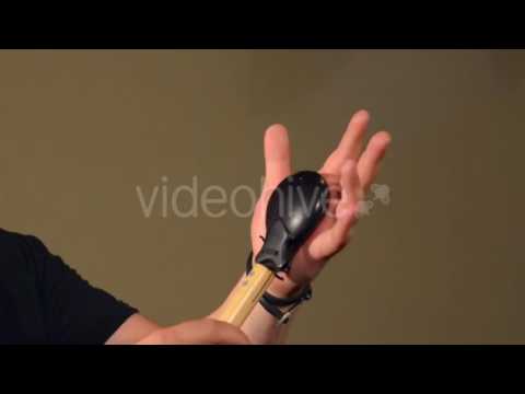 One Man Playing on the Percussion Instrument Castanets. on the Bright Walls Background.