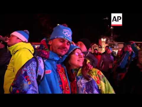 People in the mountains outside Sochi watch the opening of the Olympic Games