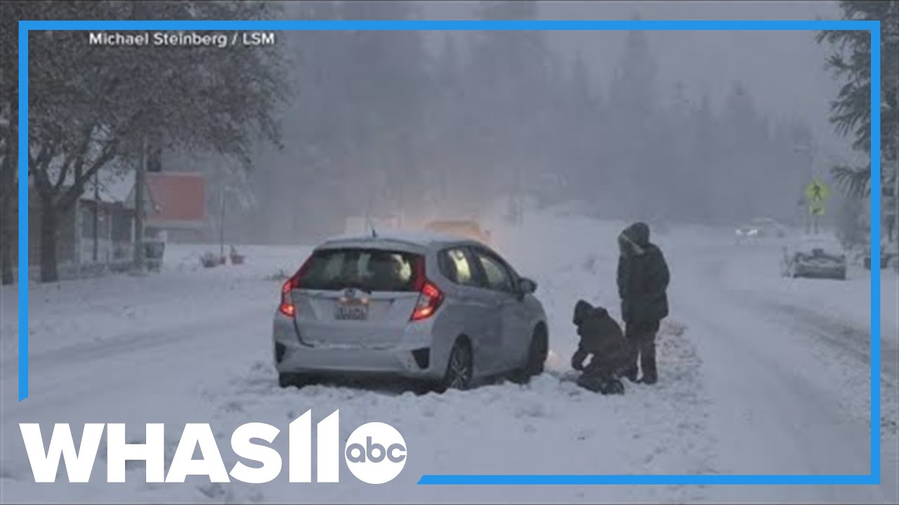 Snow and rain fall across both sides of the United States
