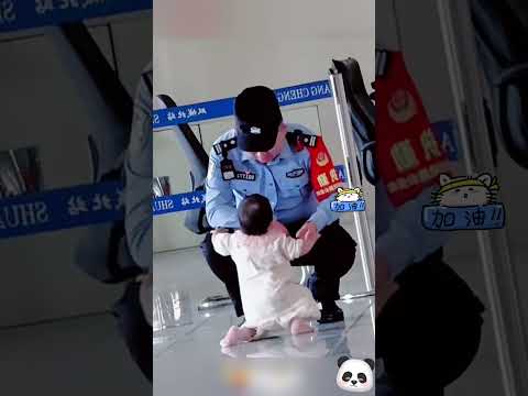 一歲寶寶在車站和家長候車時，突然爬到執勤民警面前互動討抱~