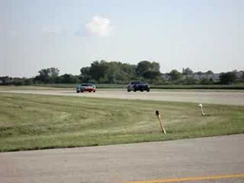 Thumbnail for Ferrari 612 and a Ford GT run side by side by Ferrari, Ford v Ferrari, Ford GT
