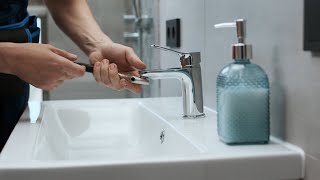 Plumber fixing the faucet